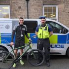 PCSO and a man standing in front of a police car with a recovered bike