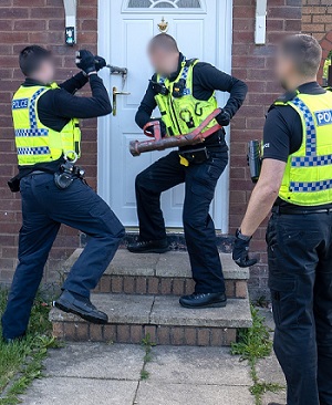 An image of an Operation Sceptre warrant being carried out. 